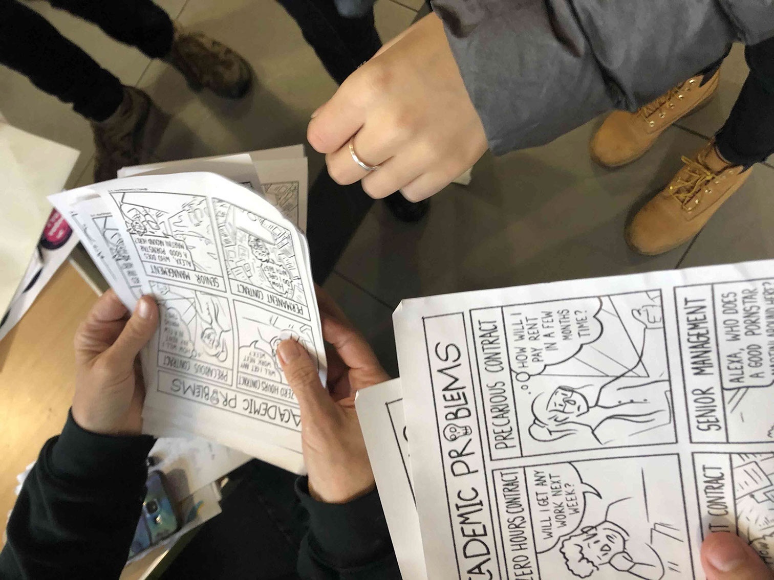 A comic being handed from person to person at the University of Manchester, illustrating outreach during the UCU strike.